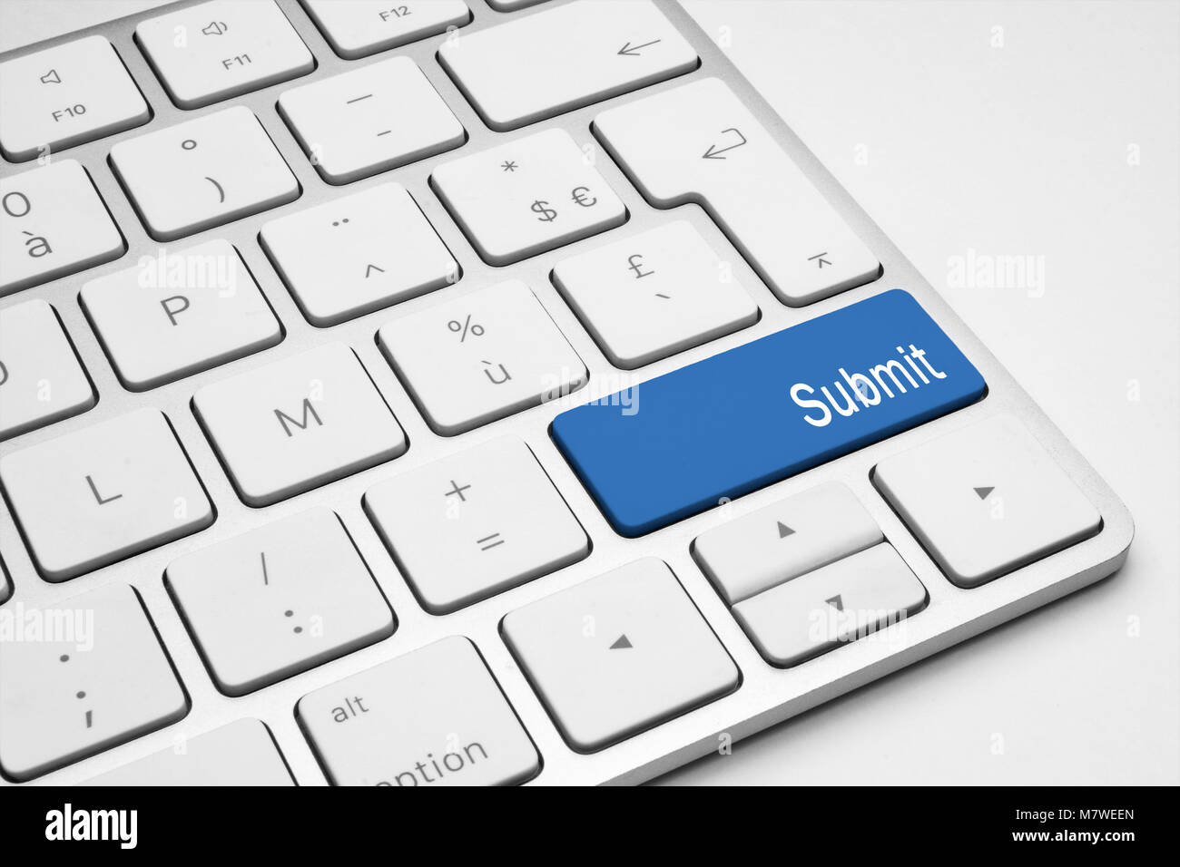 Blue Submit button on a white keyboard Stock Photo