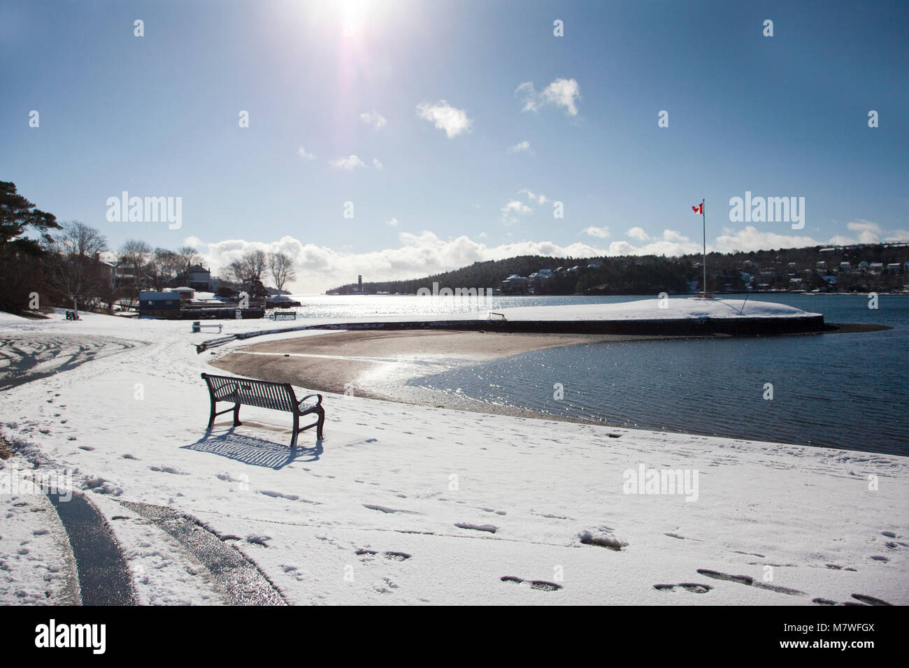 a snow covered park by a lake in wintery Canada Stock Photo