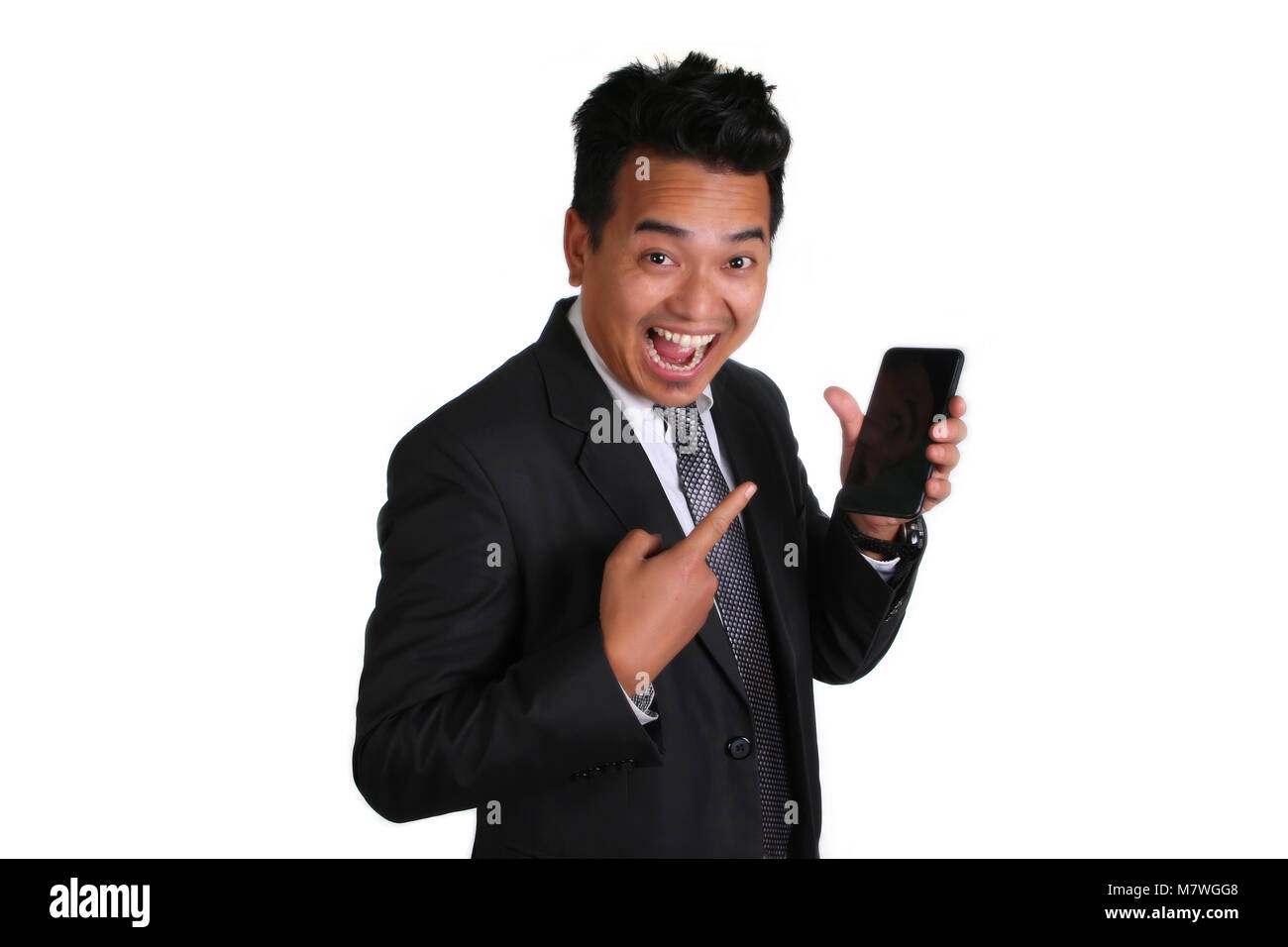 Extremely happy asian business man holding mobile phone isolated on white background. Stock Photo
