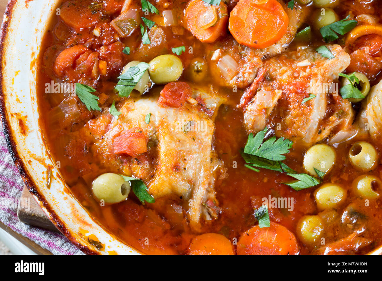 Italian style Chicken cacciatore in an ovenproof casserole dish Stock Photo