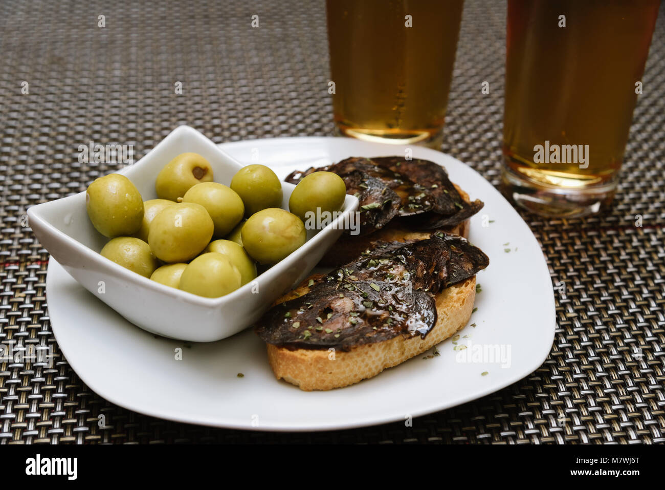 Spanish tapa set with olives and chorizo, a spicy Spanish pork sausage