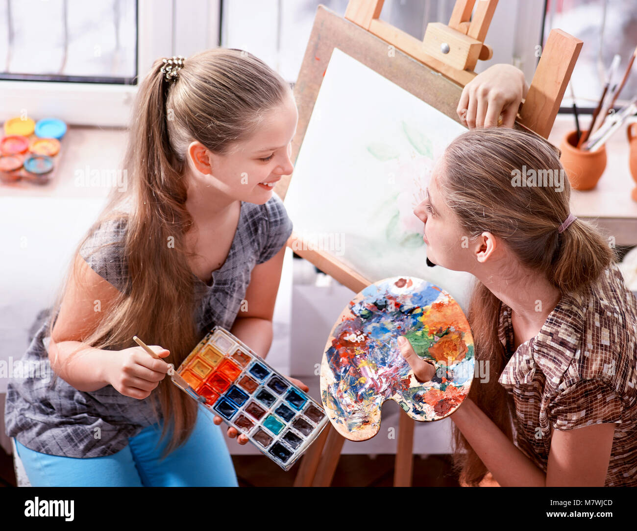 Artist painting on easel in studio. Authentic children paints Stock ...