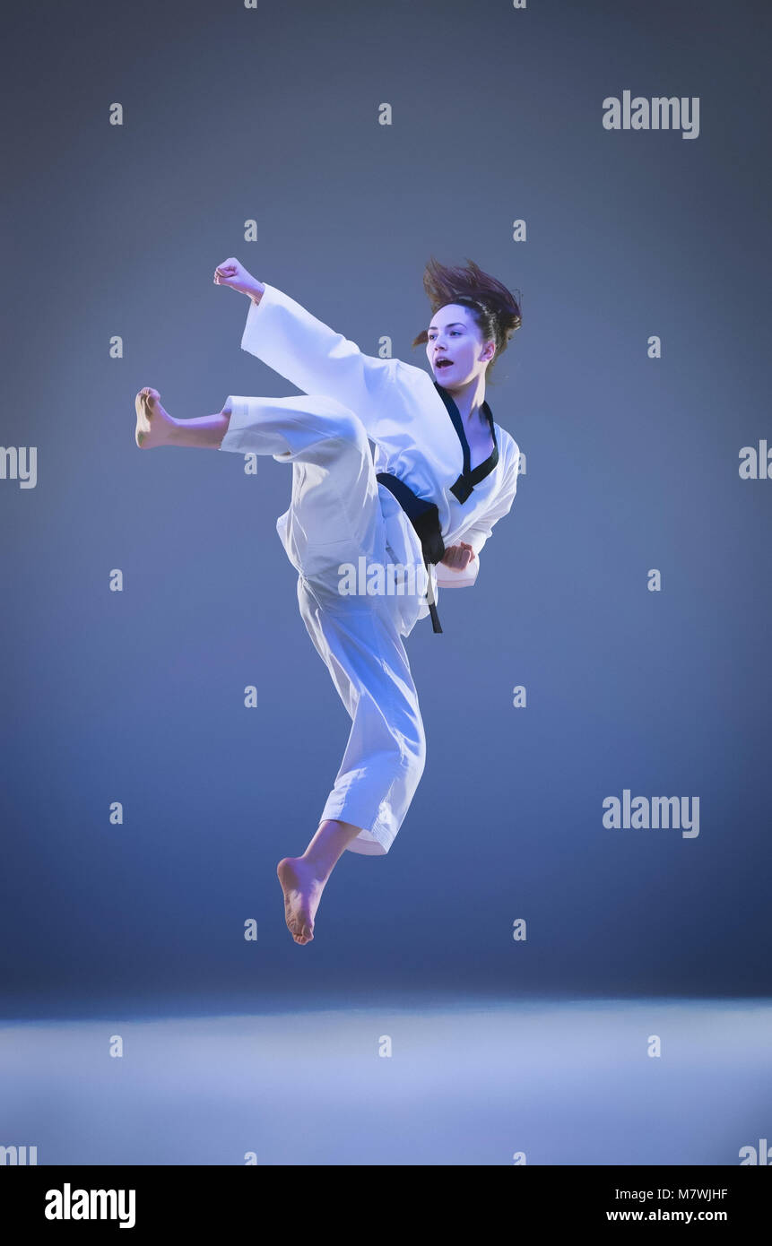 The karate girl with black belt Stock Photo