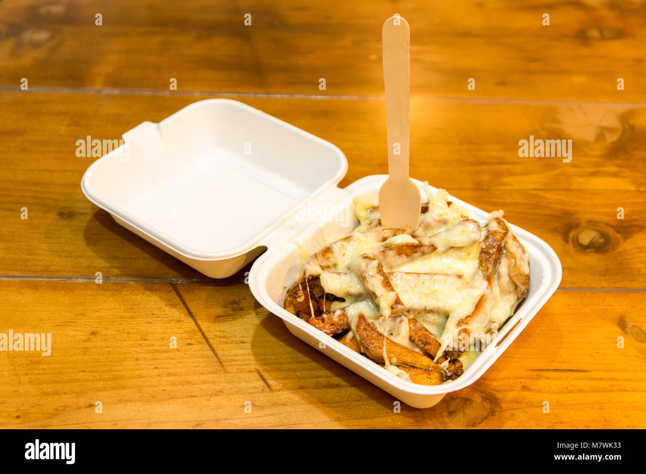 Home made Cheesy Chips in Take Away Carton Stock Photo