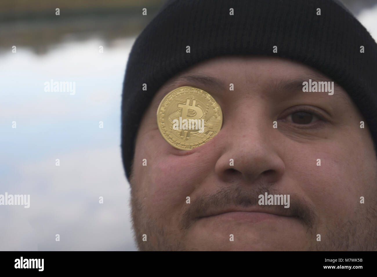 a serious man with bitcoin (new virtual money ) Stock Photo