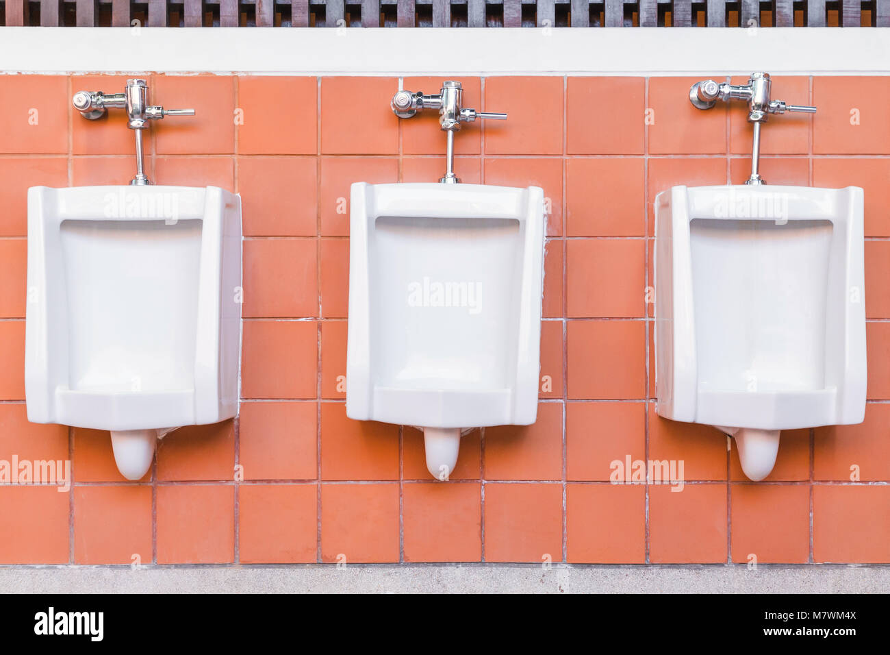 Toilet of man. Tiles wall in the toilet of man with many urinal. Interior  of toilet with urinal in the public toilet. Design of white ceramic urinal  Stock Photo - Alamy