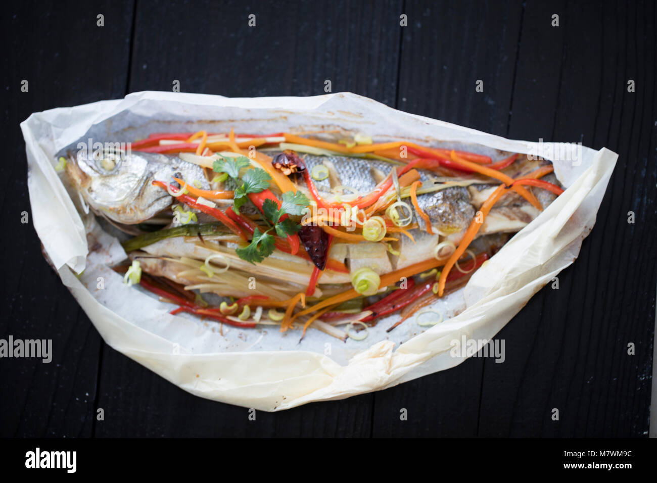 cooking and marinating sea fish . red perch with lemon , pepper on