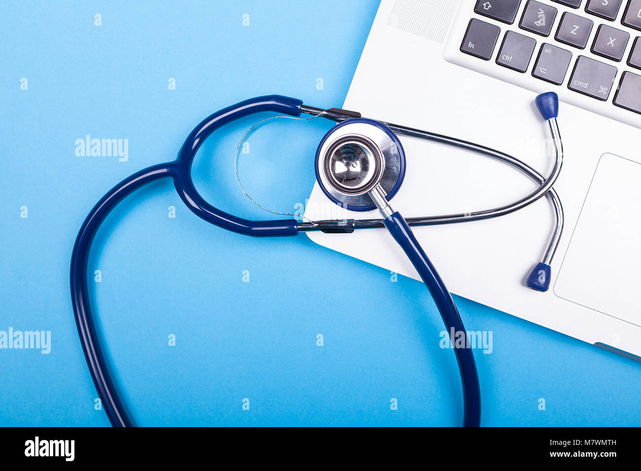 Medicinal stethoscope lying over a laptop Stock Photo - Alamy