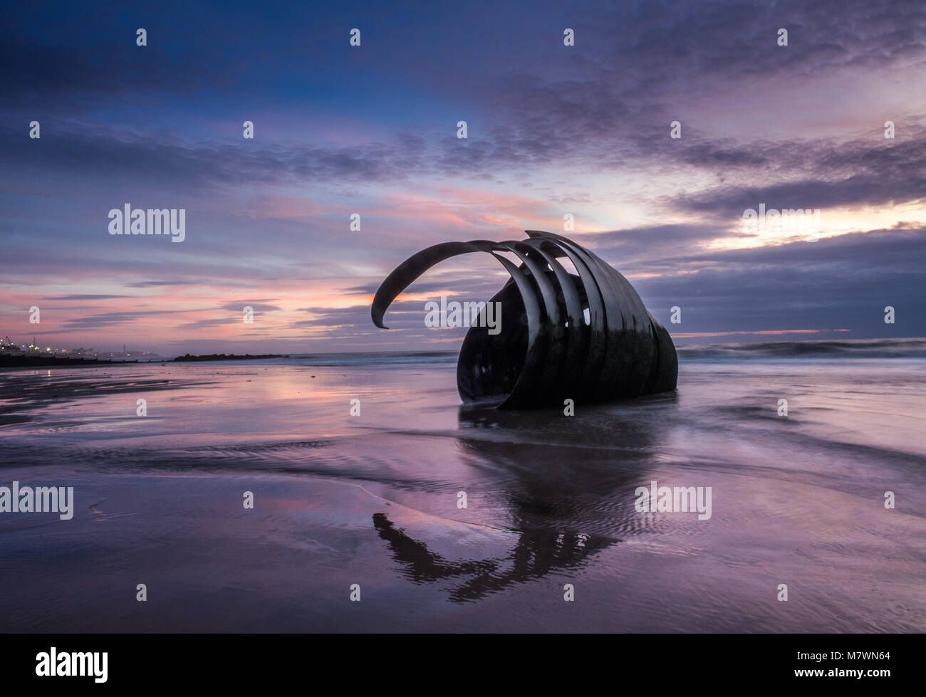 Sunset at the beach at Cleveleys on the Lancashire Coast with the artwork Mary's Shell  in the foreground Stock Photo
