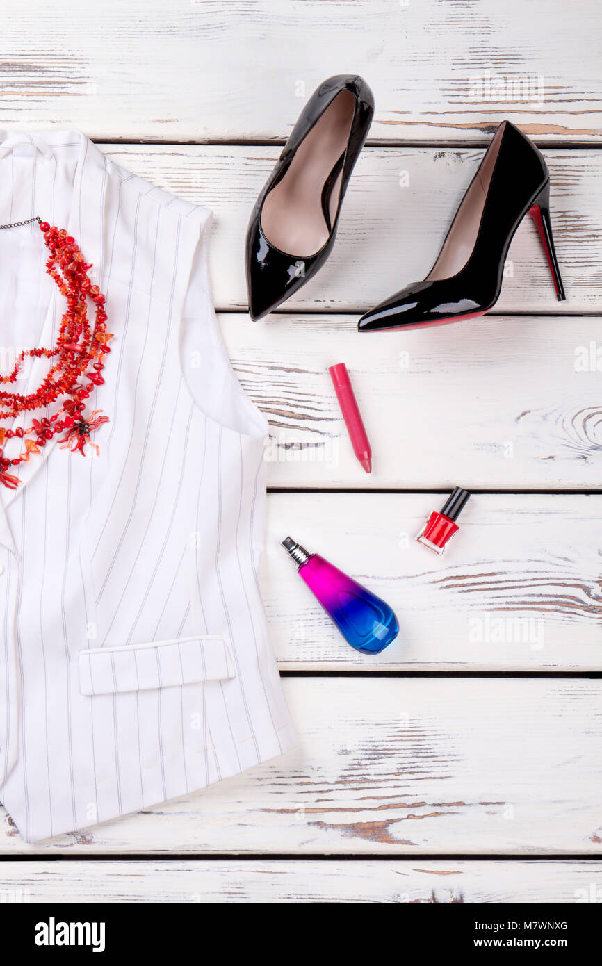Top view black high heel shoes. Wooden desks surface background Stock