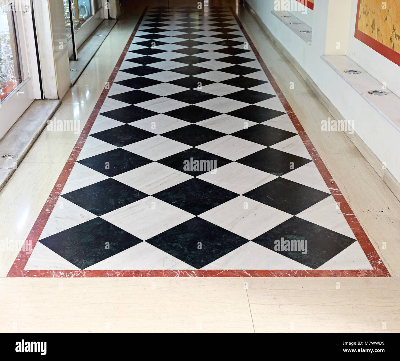 Black And White Checkered Floor Tiles In Corridor Stock Photo