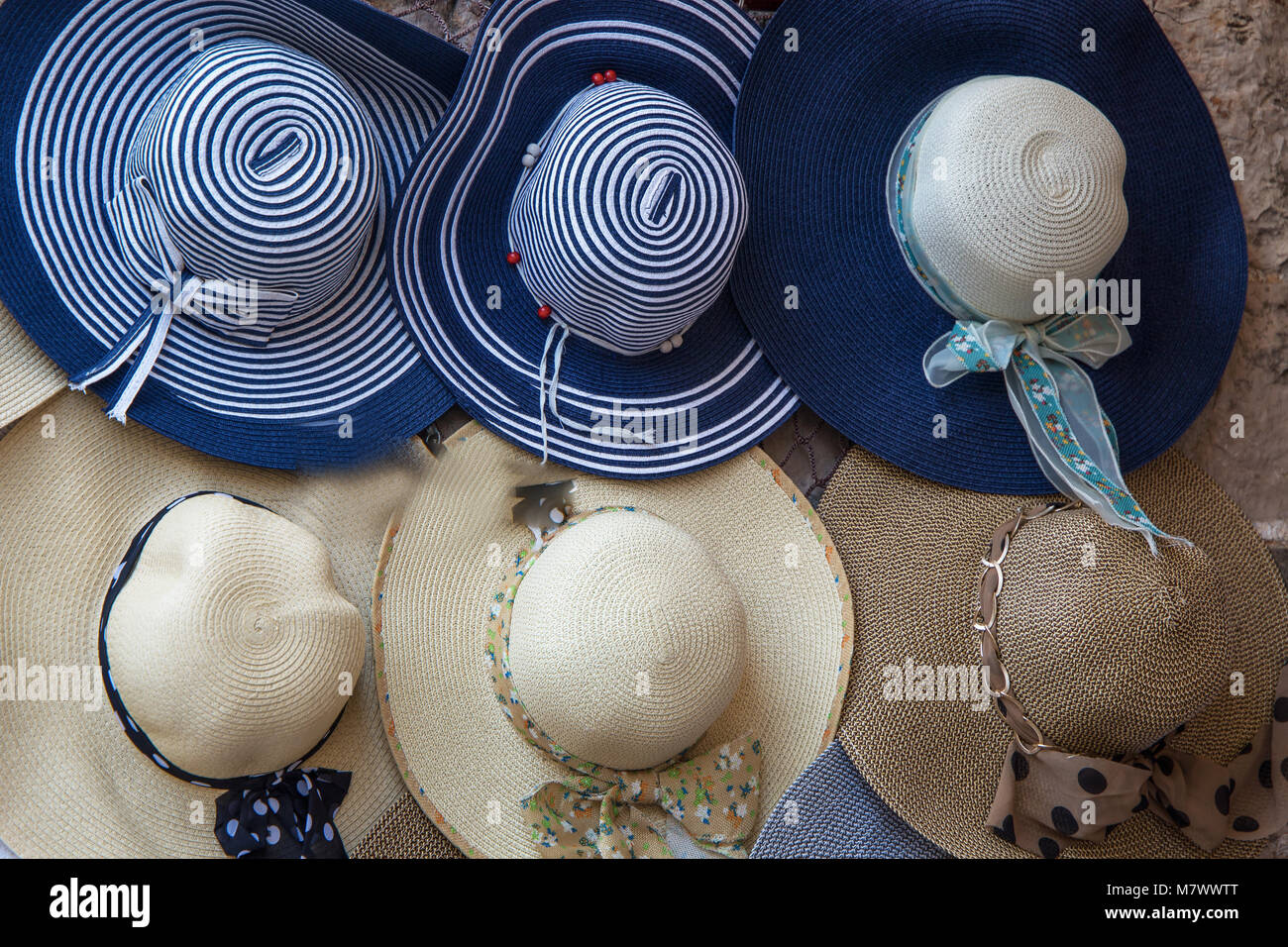 Elegant colorful women straw hats collection,hats for sale at a market Stock Photo