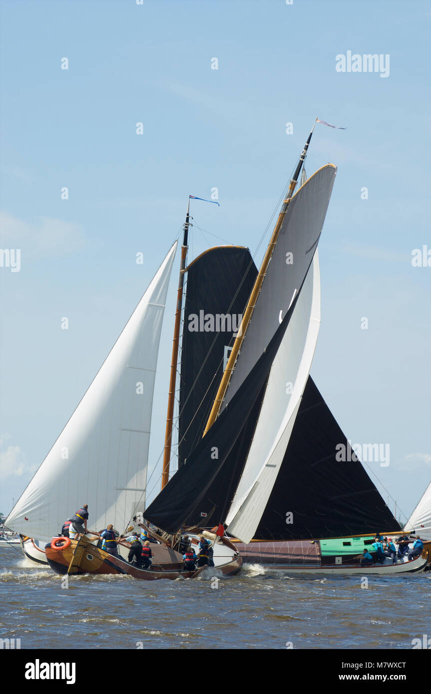 A traditional sailing race called skutsjesilen with classic Dutch wooden flatbottemend boats on