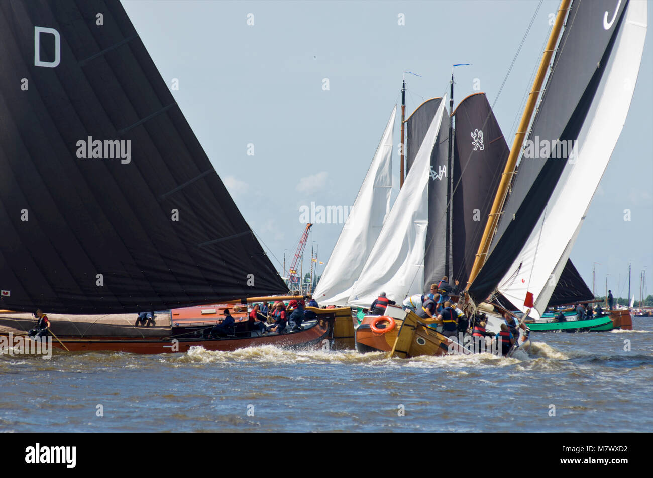 A traditional sailing race called skutsjesilen with classic Dutch wooden flatbottemend boats on