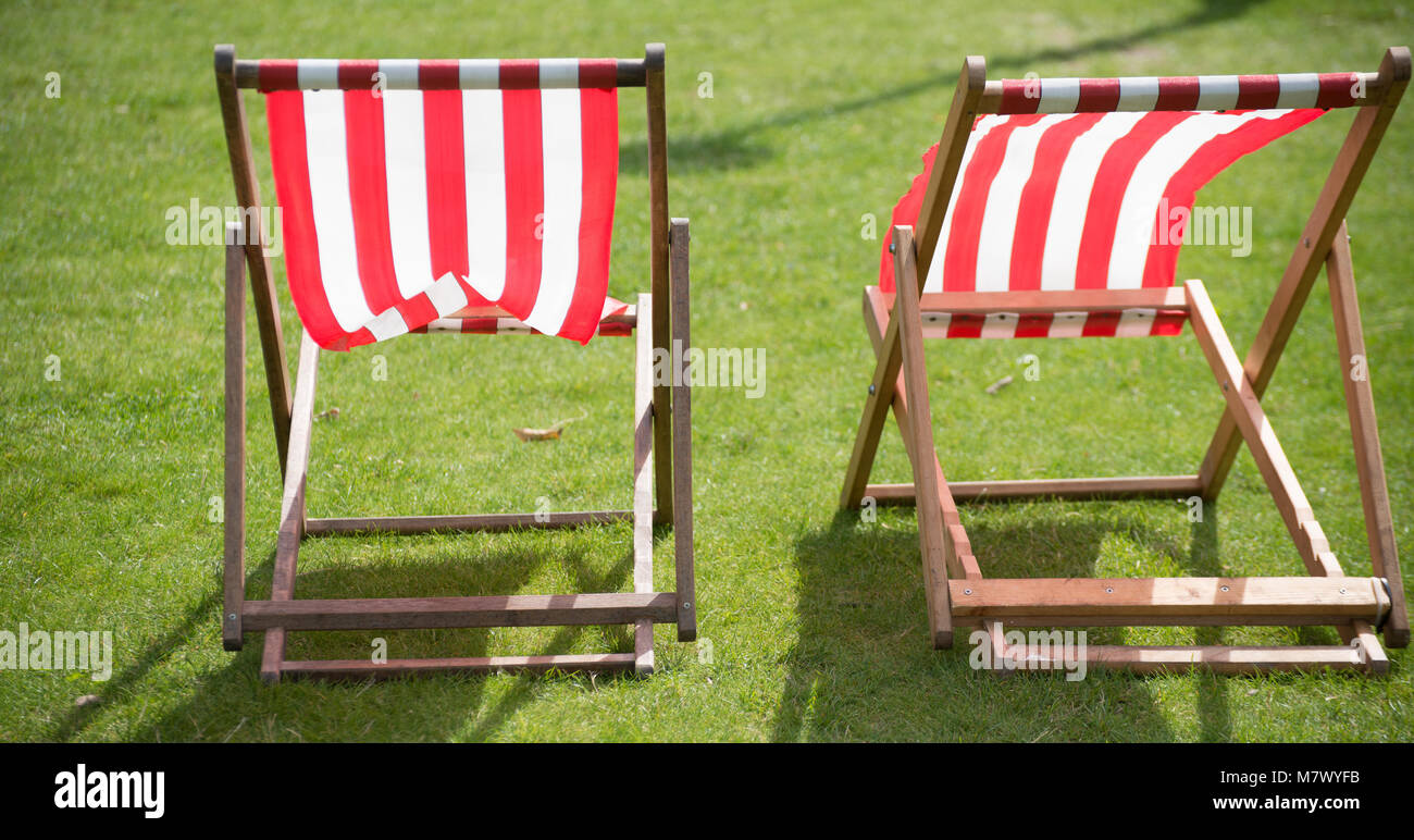 isolated unoccupied deck chairs in English garden Stock Photo Alamy