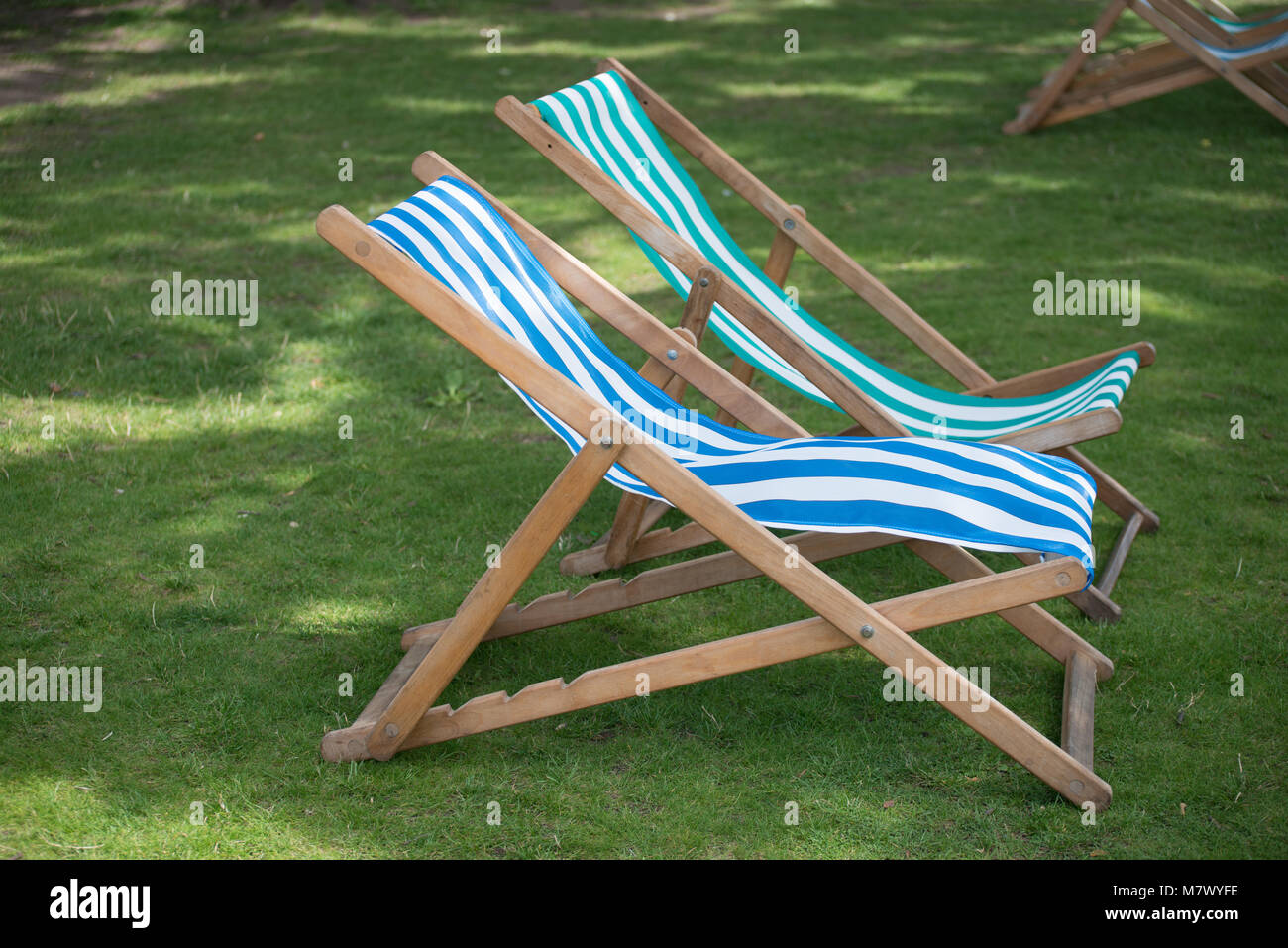 isolated unoccupied deck chairs in English garden Stock Photo Alamy