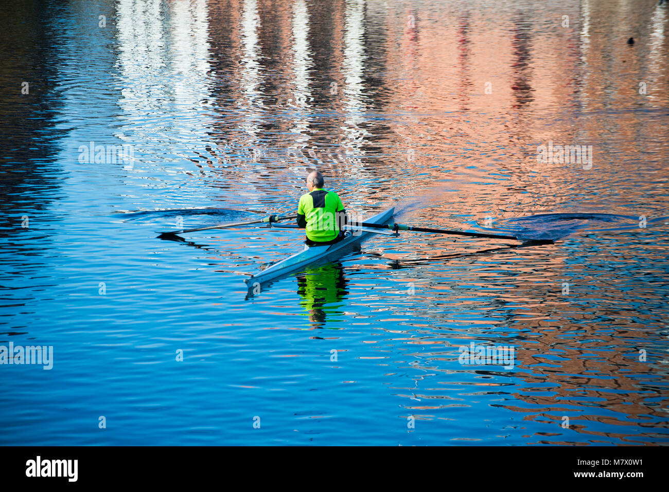 single isolated competitive rower in training on river Avon with ...