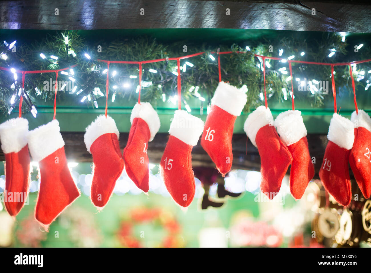 Red Christmas Stockings Hanging In Fireplace With Cheeky Elf