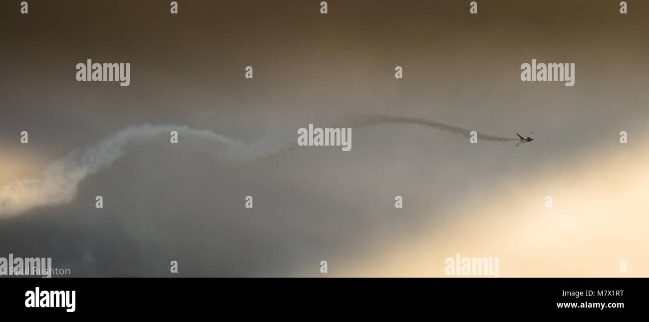 McDonnell Douglas f15 jet fighter aircraft completes barrel roll in