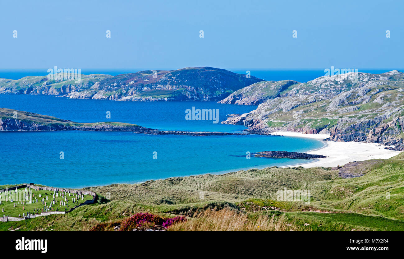 Looking over azure sea and white sand beach at Oldshoremore Bay, near Kinlochbervie, Sutherland, Scotland, old coastal cemetery in view on left. Stock Photo