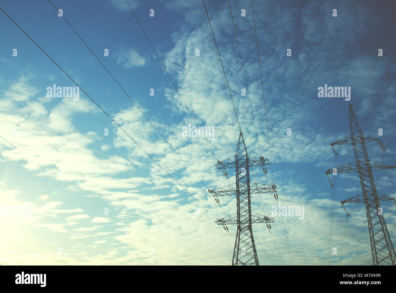 power lines against the blue sky and white clouds Stock Photo - Alamy