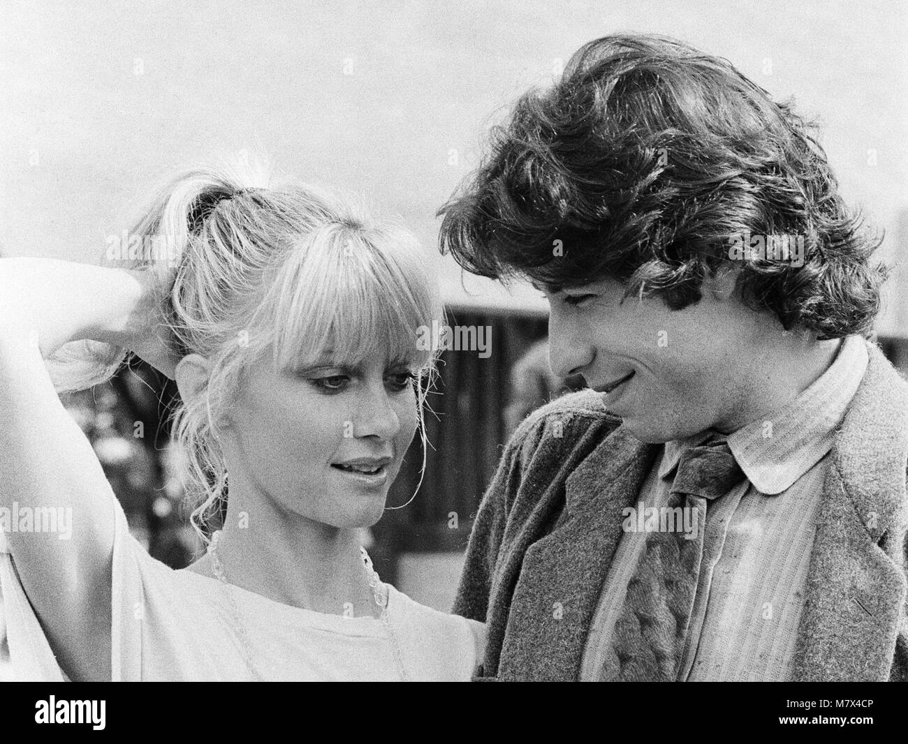 John Travolta and his co star Olivia Newton John in England during the week of release of the film Grease.  Grease was released in the UK on 14th September 1978.  Grease is a 1978 American musical romantic comedy film based on Jim Jacobs and Warren Casey's musical of the same name. The film depicts the life of Rydell High School students Danny Zuko and Sandy Olsson in the late 1950s.  Directed by Randal Kleiser and written by Bronte Woodard, the film stars John Travolta as Danny, Olivia Newton-John as Sandy and Stockard Channing as Betty Rizzo. Grease was successful both critically and commerc Stock Photo