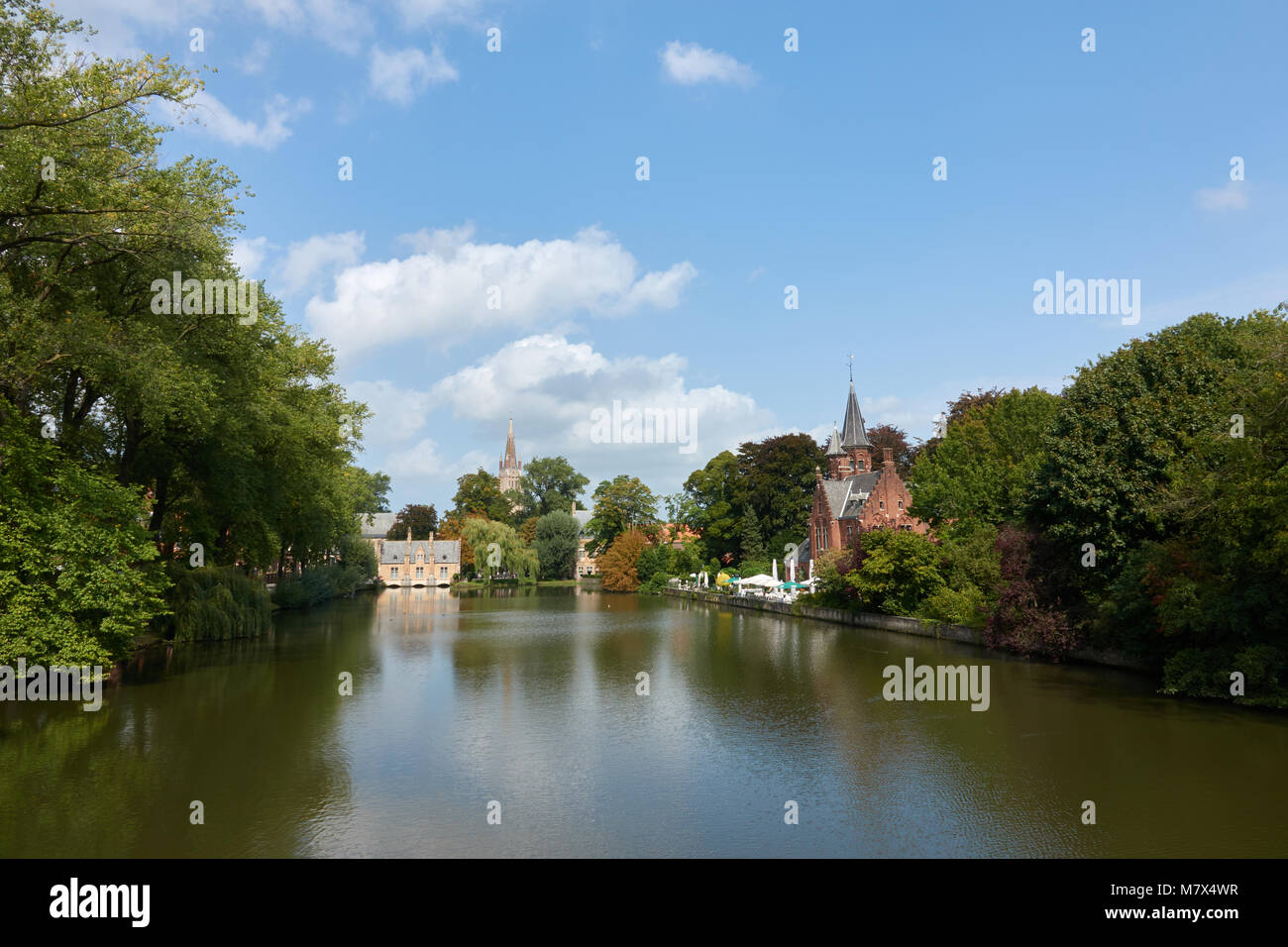 The most beautiful scenic place. Medieval houses on the shore of the lake. Green trees and a blue summer sky. Stock Photo