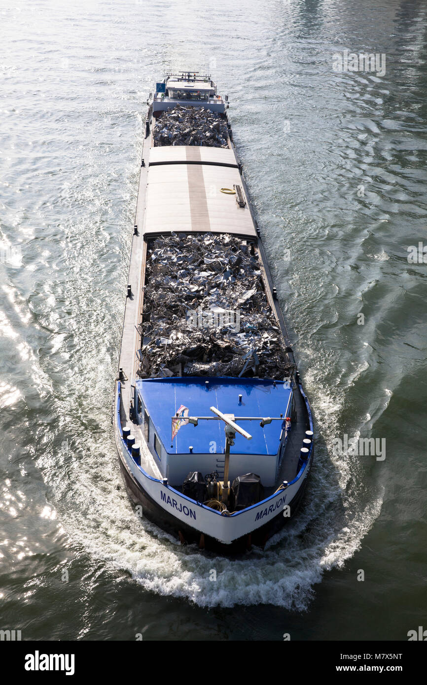 Germany, Cologne, cargo ship with scrap metal on the river Rhine.  Deutschland, Koeln, Frachtschiff mit Altmetall auf dem Rhein. Stock Photo