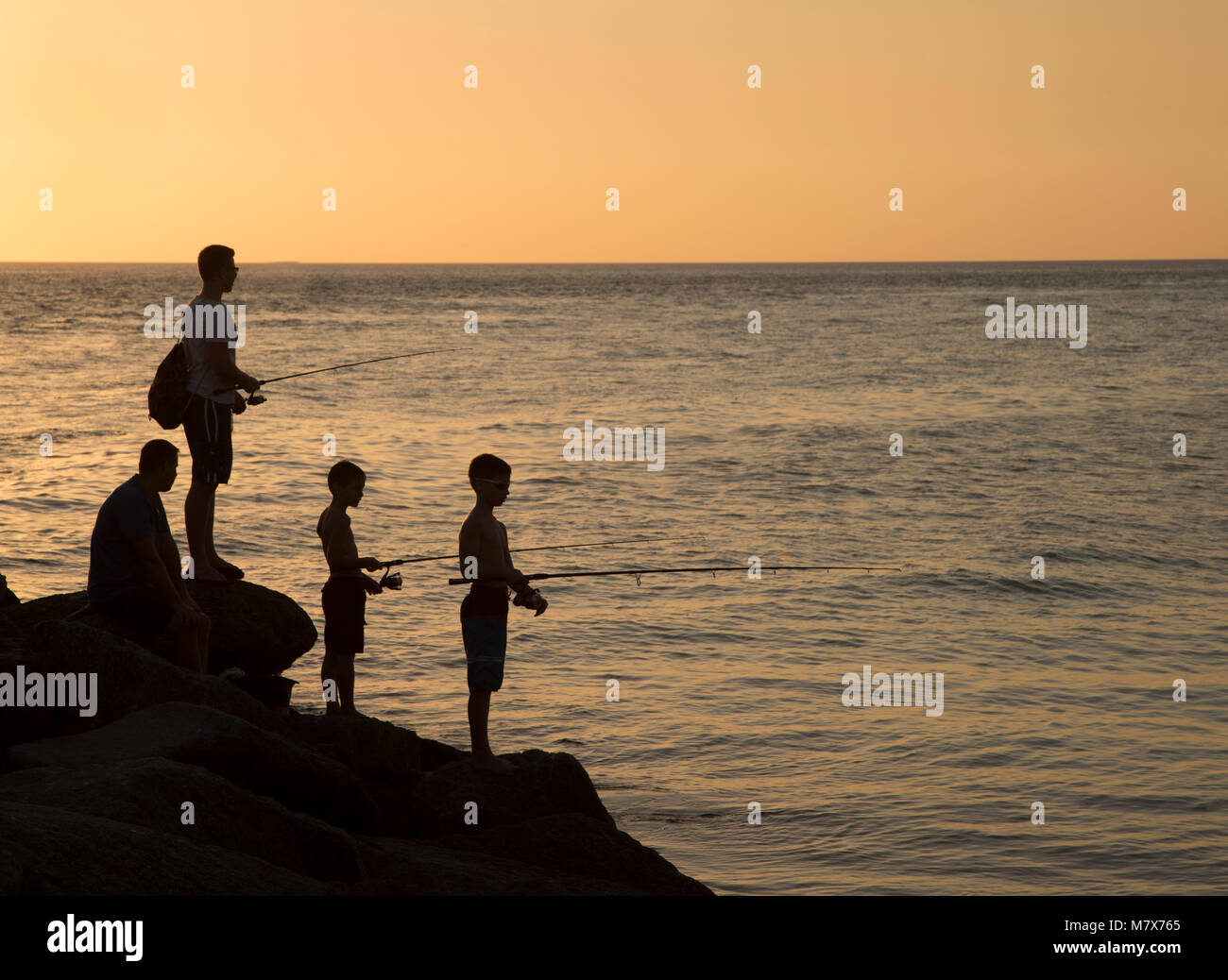 Man and boys fishing in Gulf of Mexico off North Jetty in Nokomis