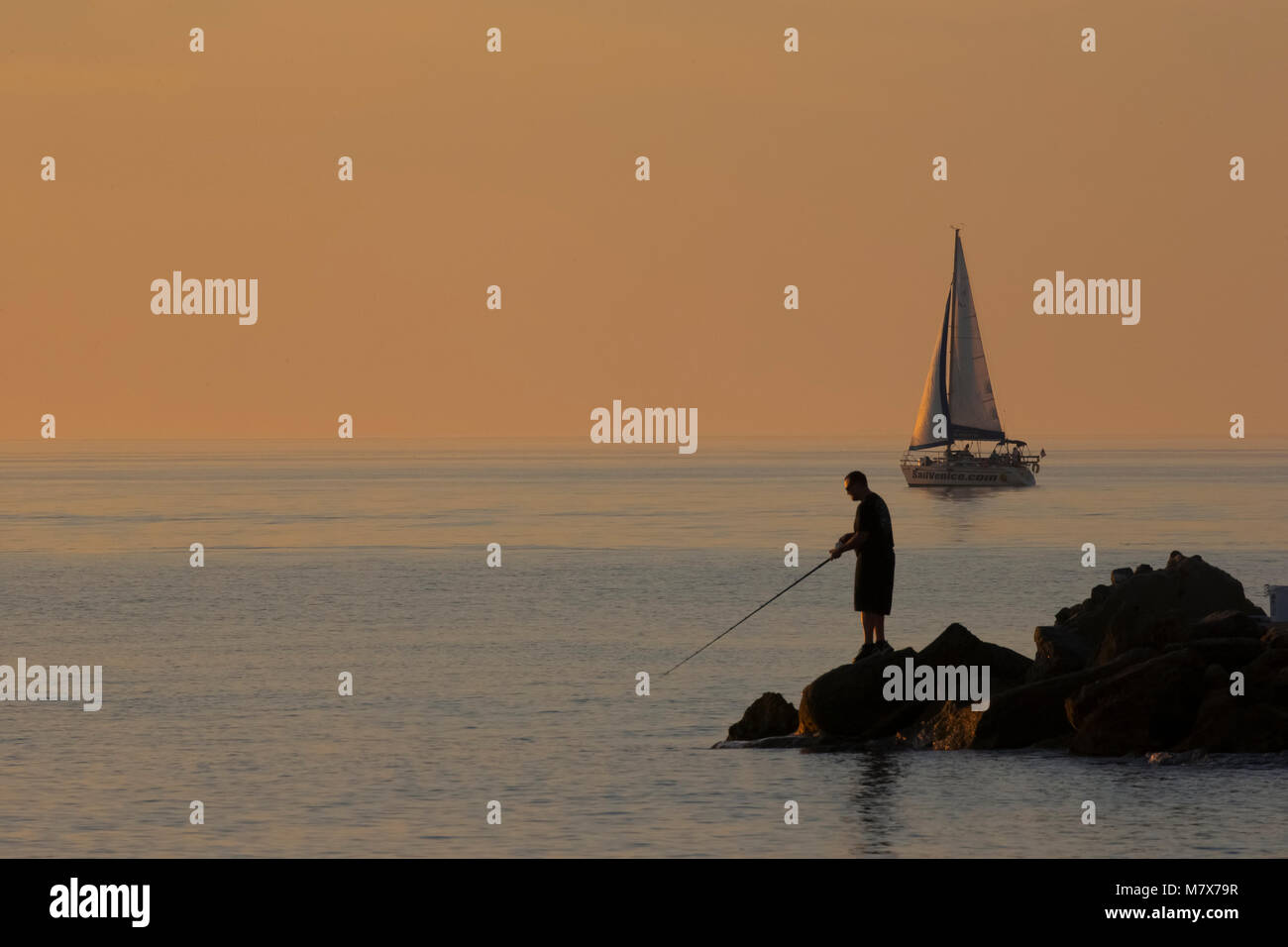 Fishing at sunset in the Gulf of Mexico on the North Jetty in Venice