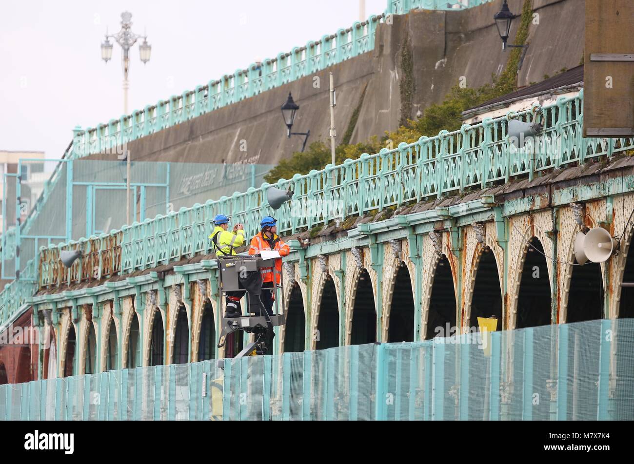 Surveyors examine the iron work on Madeira Terrace on Brighton seafront. A total of 148 arches are to be fully restored at an estimated cost of  more than £24 million pounds. The entire Grade II-listed cast iron structure that forms Brighton's Madeira Terraces has been closed to the public over fears parts could collapse. Stock Photo