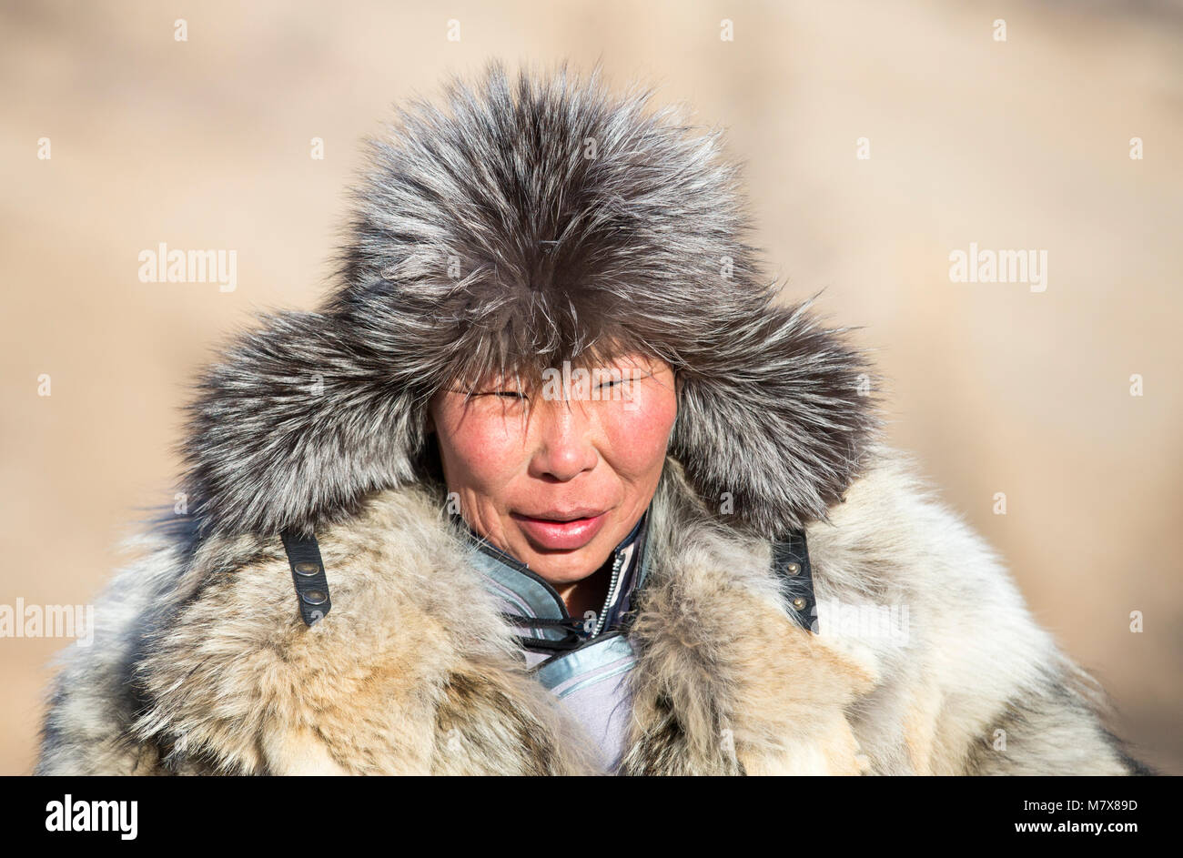 Hatgal, Mongolia, 4th March 2018: mongolian people dressed in traditional clothing on a frozen lake Khuvsgul Stock Photo