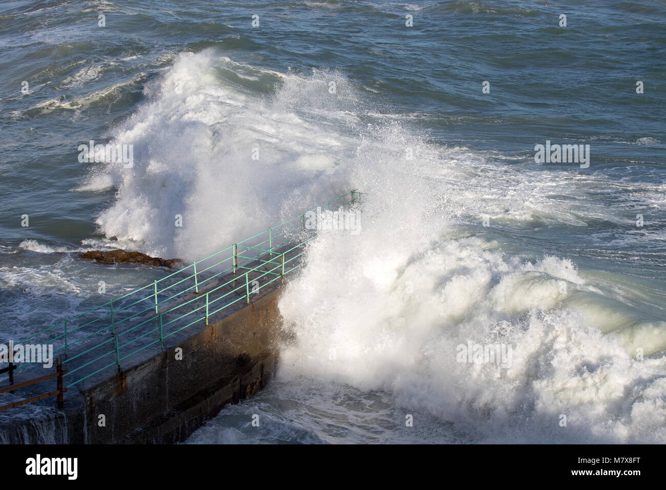 Rough Sea Waves Crashing Over a Pier, mediterranean sea, ligurian coast, Italy. Stock Photo