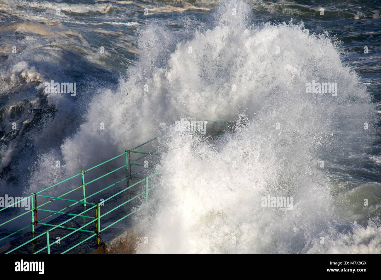 Rough Sea Waves Crashing Over a Pier, mediterranean sea, ligurian coast, Italy. Stock Photo