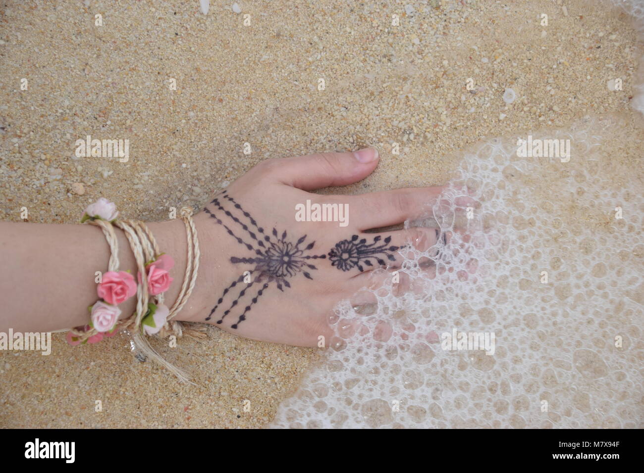 Nothing is more relaxing than feeling the sands and water, It is always good to connect to the mother earth! Stock Photo