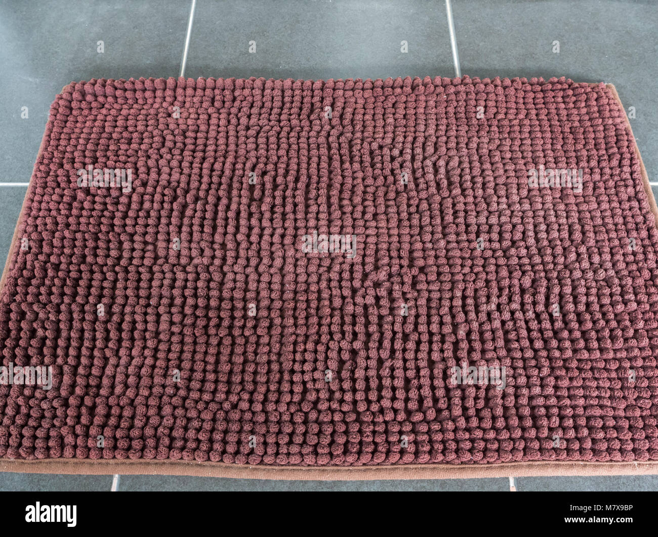 Soft Brown Door Mat On The Tile Floor In Front Of The Door