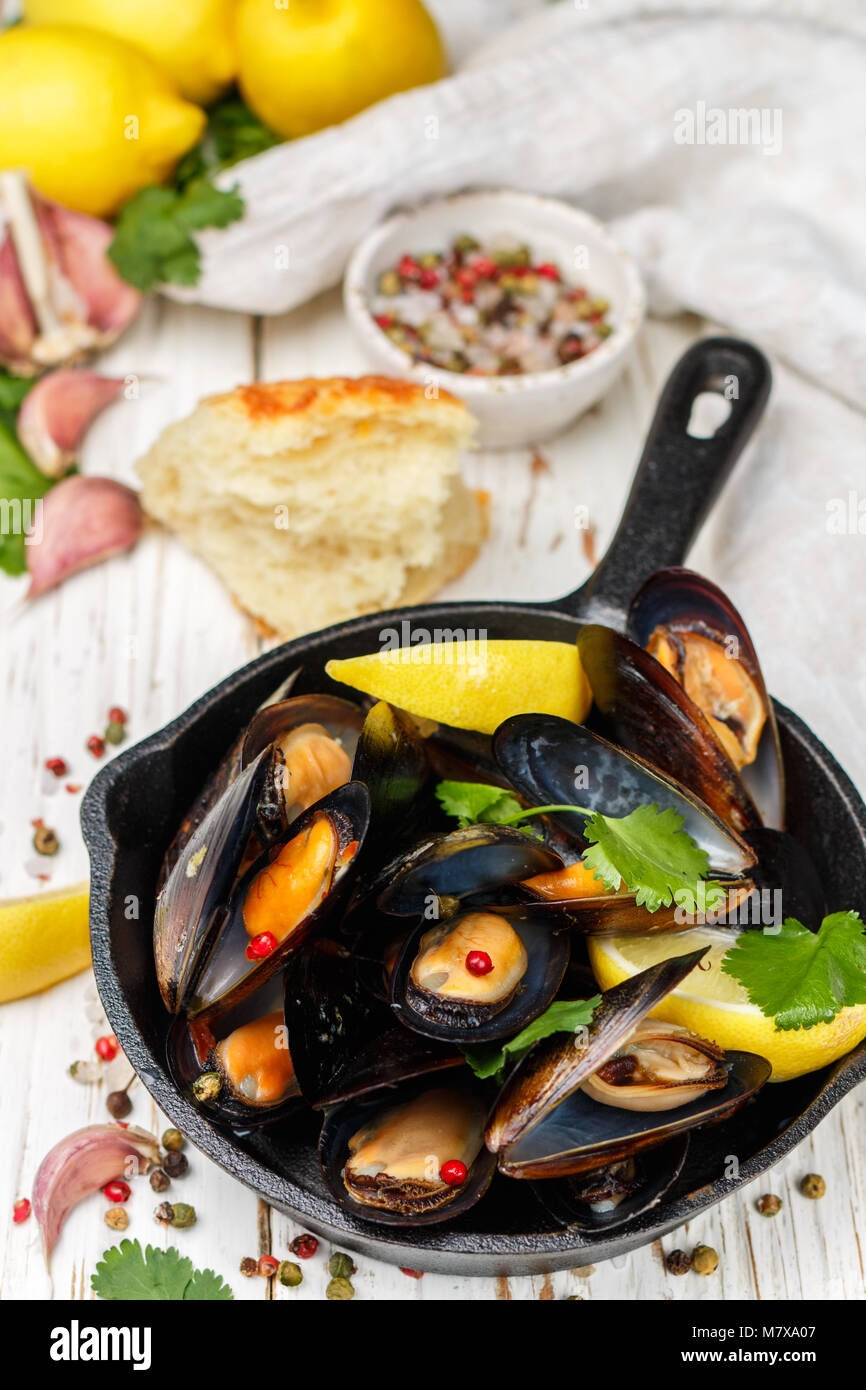 Delicious mussels in white wine with lemon, garlic, herbs and spices in