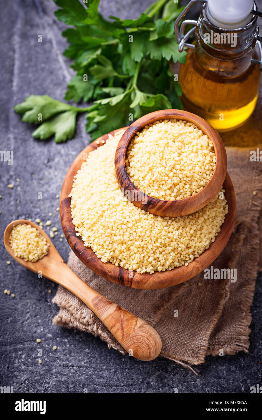 Couscous grain in wooden bowl Stock Photo Alamy