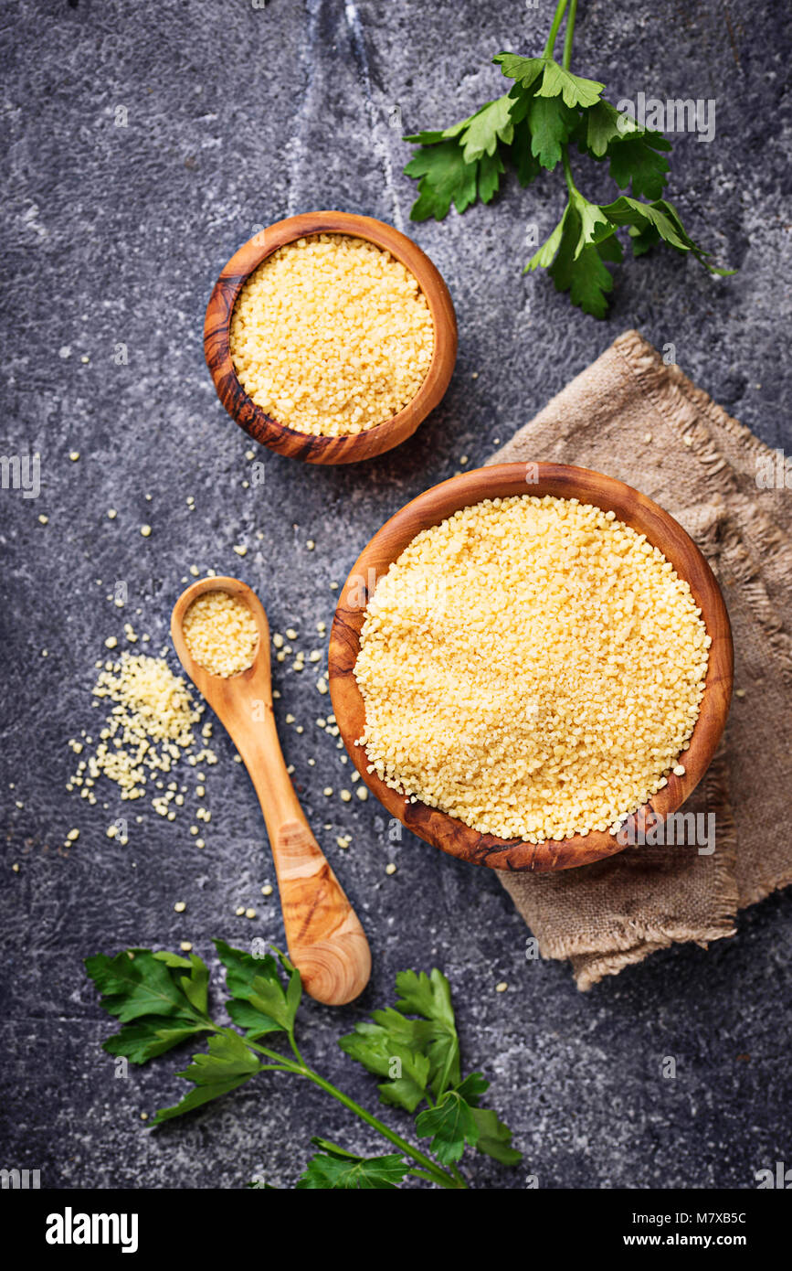 Couscous grain in wooden bowl Stock Photo Alamy