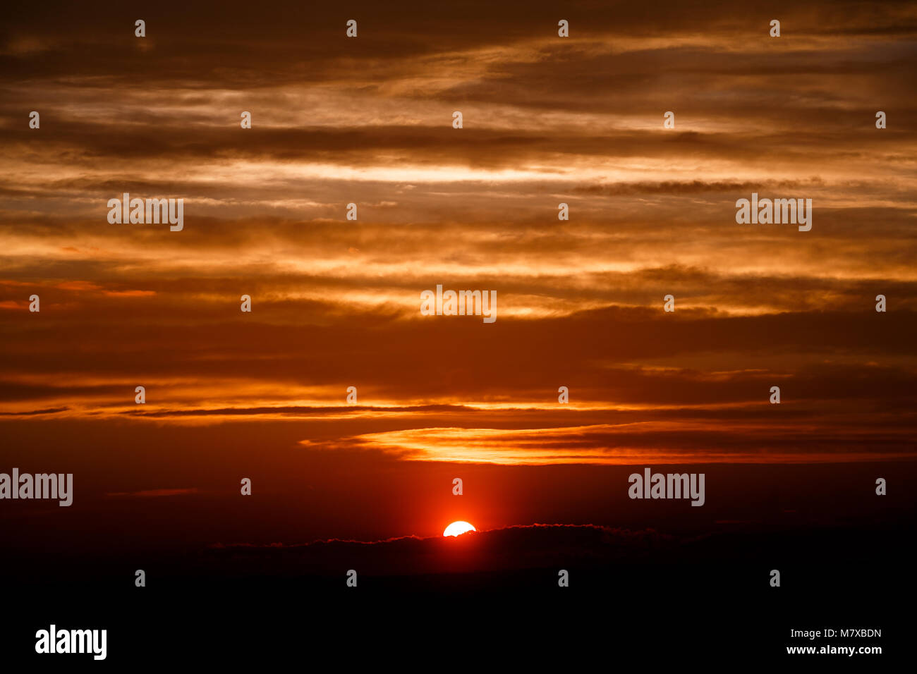 amazing sunset wallpaper. beautiful red sunset and clouds in orange sky, dramatic view. fascinating image. beautiful nature moments, breathtaking scen Stock Photo
