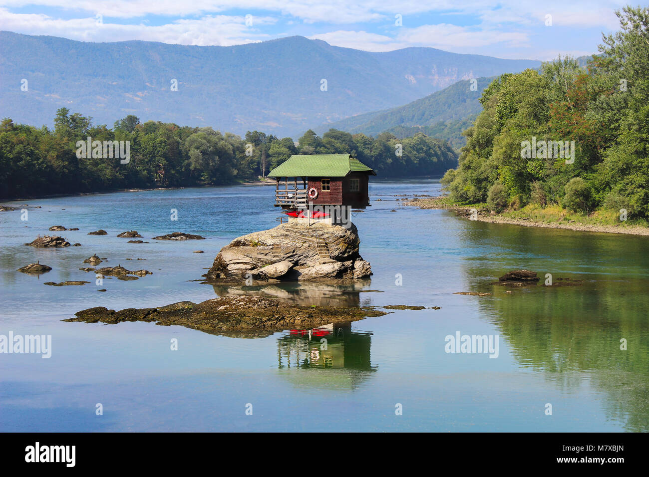 Unique colorful little house, built on the rock in the middle of Drina river in Serbia. One of the landmarks and touristic attractions of this area. Stock Photo