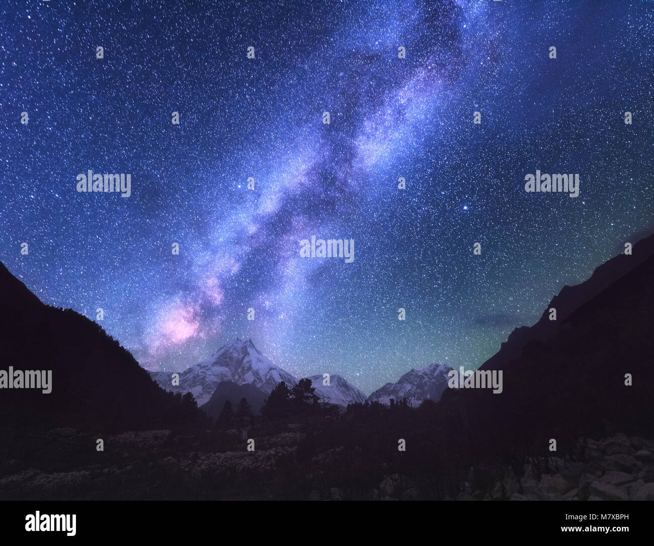 Space. Milky Way. Amazing scene with himalayan mountains and starry sky at night in Nepal. High rocks with snowy peak and sky with stars. Manaslu, Him Stock Photo