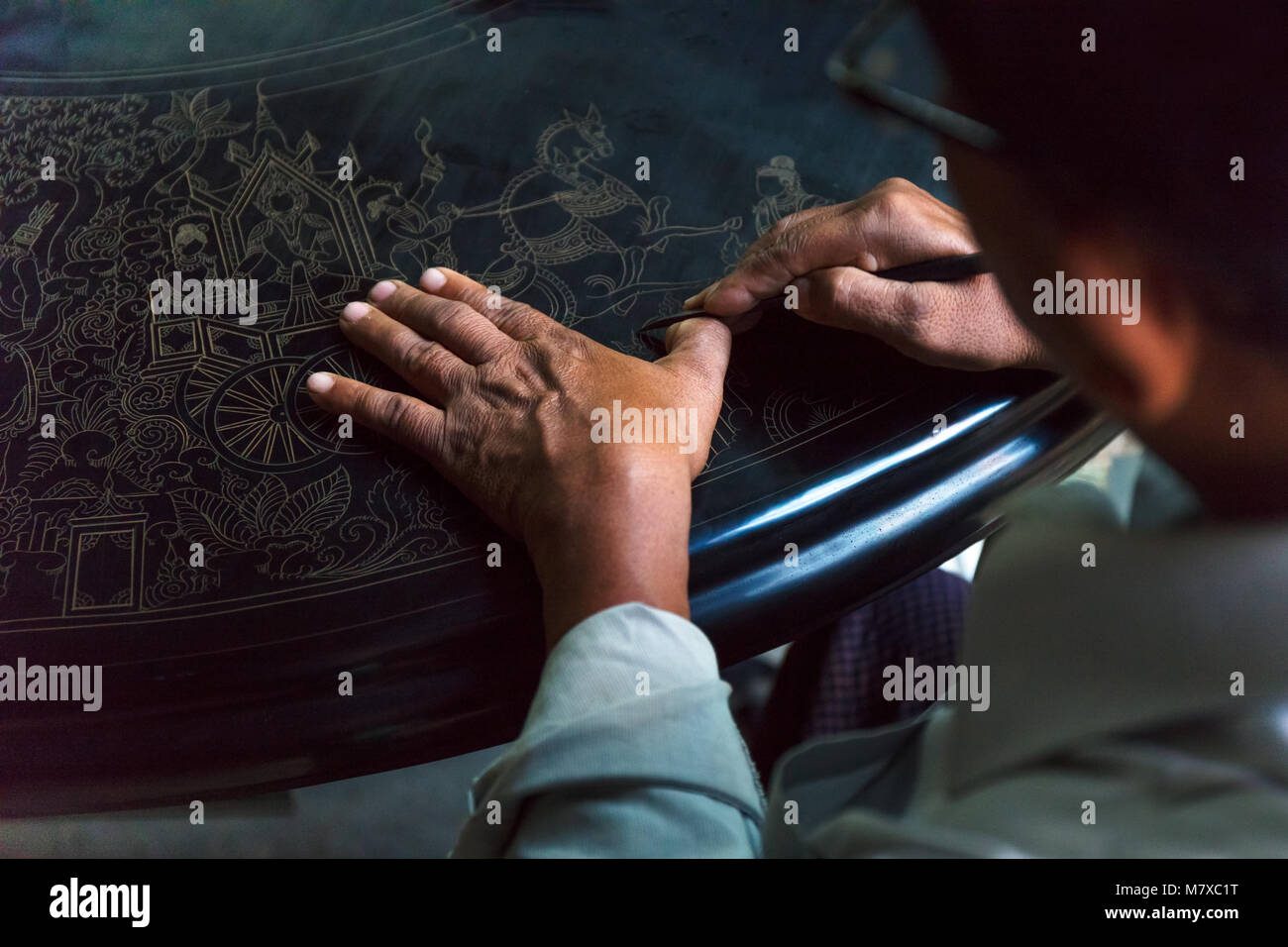 A Lacquerware artisan drawing artwork in a Bagan's Myanmar