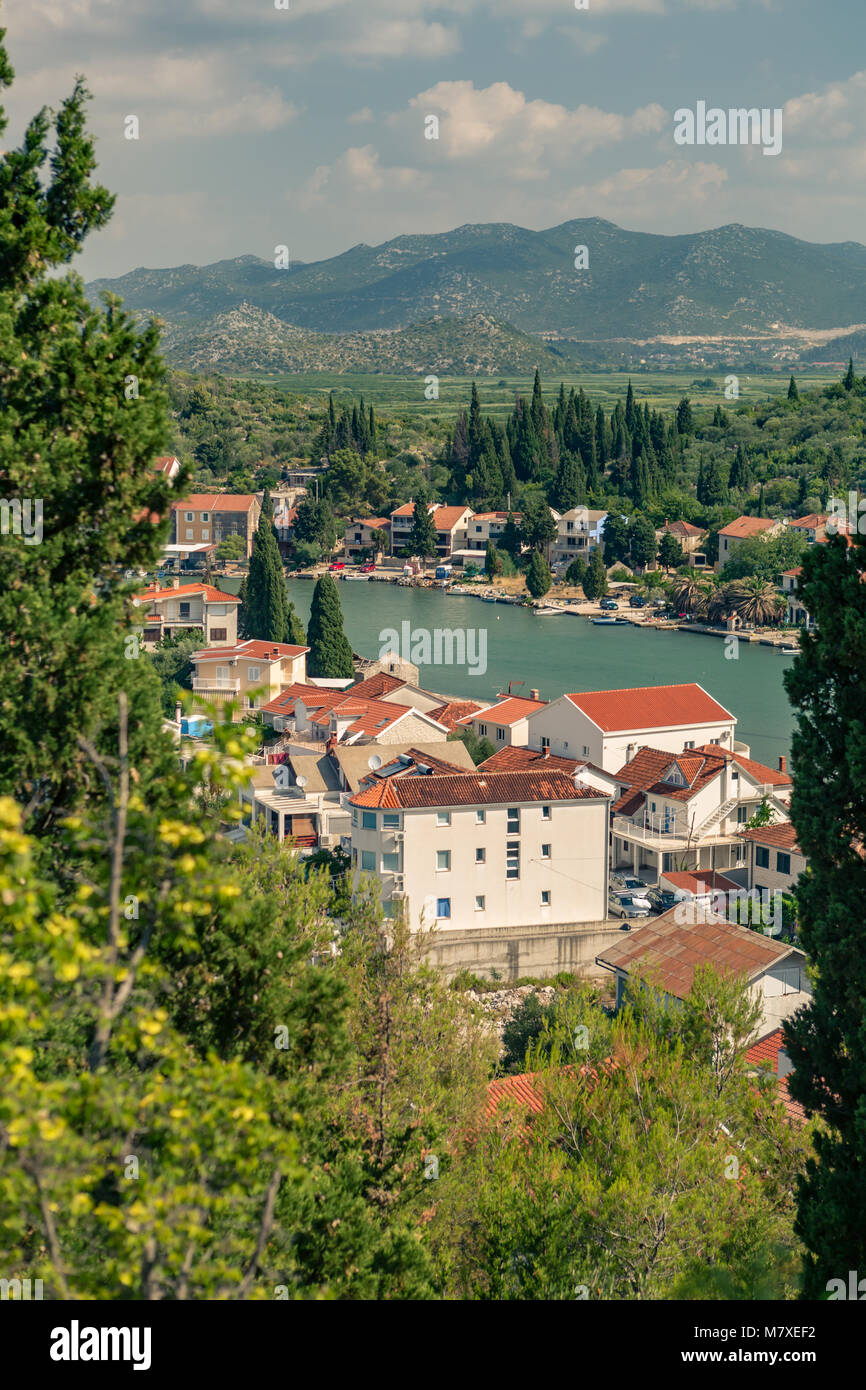 Inspirational beautiful landscape in mediterranean town with sea, coast and valley. City in green valley Opuzen, Croatia. Stock Photo