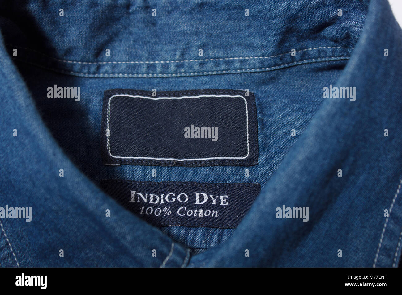 Blue denim Shirt with empty label on collar Stock Photo - Alamy