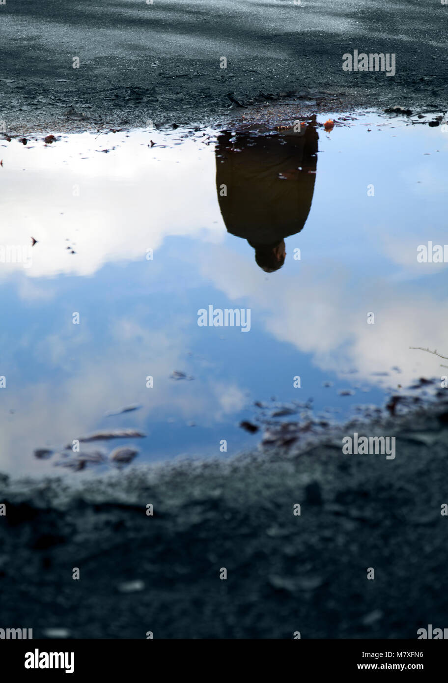 Man Reflection in Puddle Stock Photo
