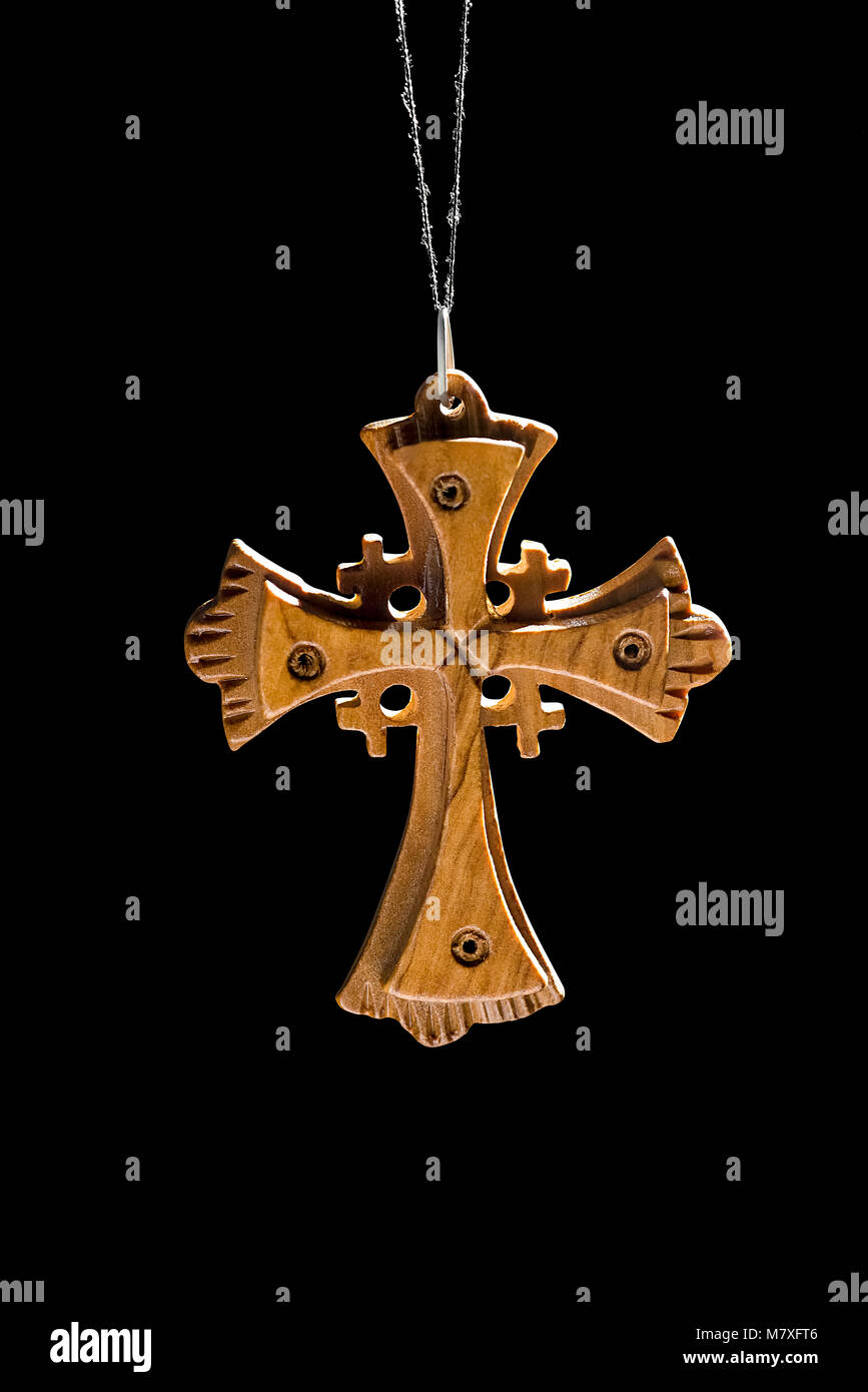 Wooden cross hanging on a black background Stock Photo Alamy