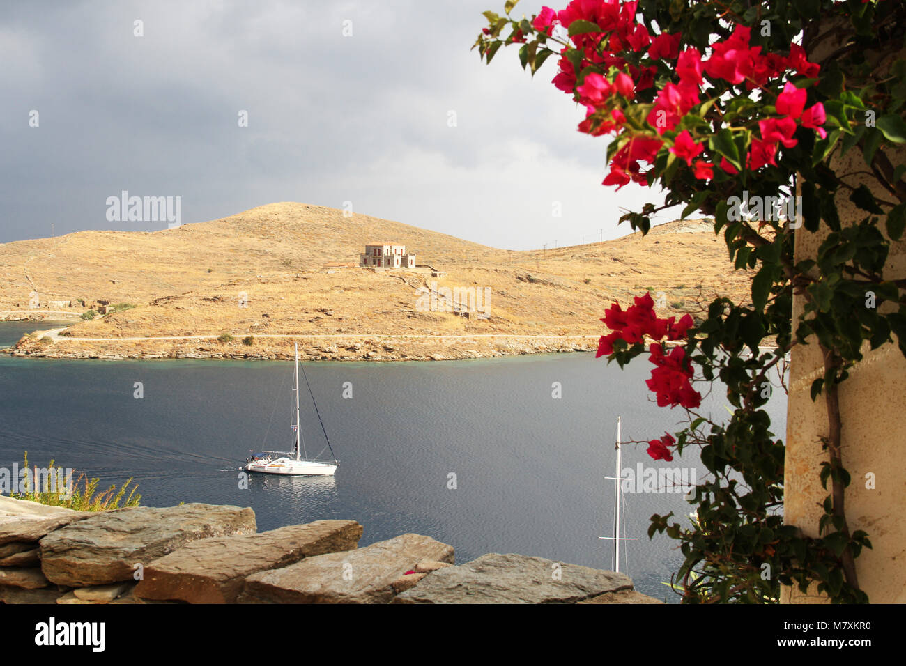 Sailing yacht rushing into the harbour before the storm in Kea island