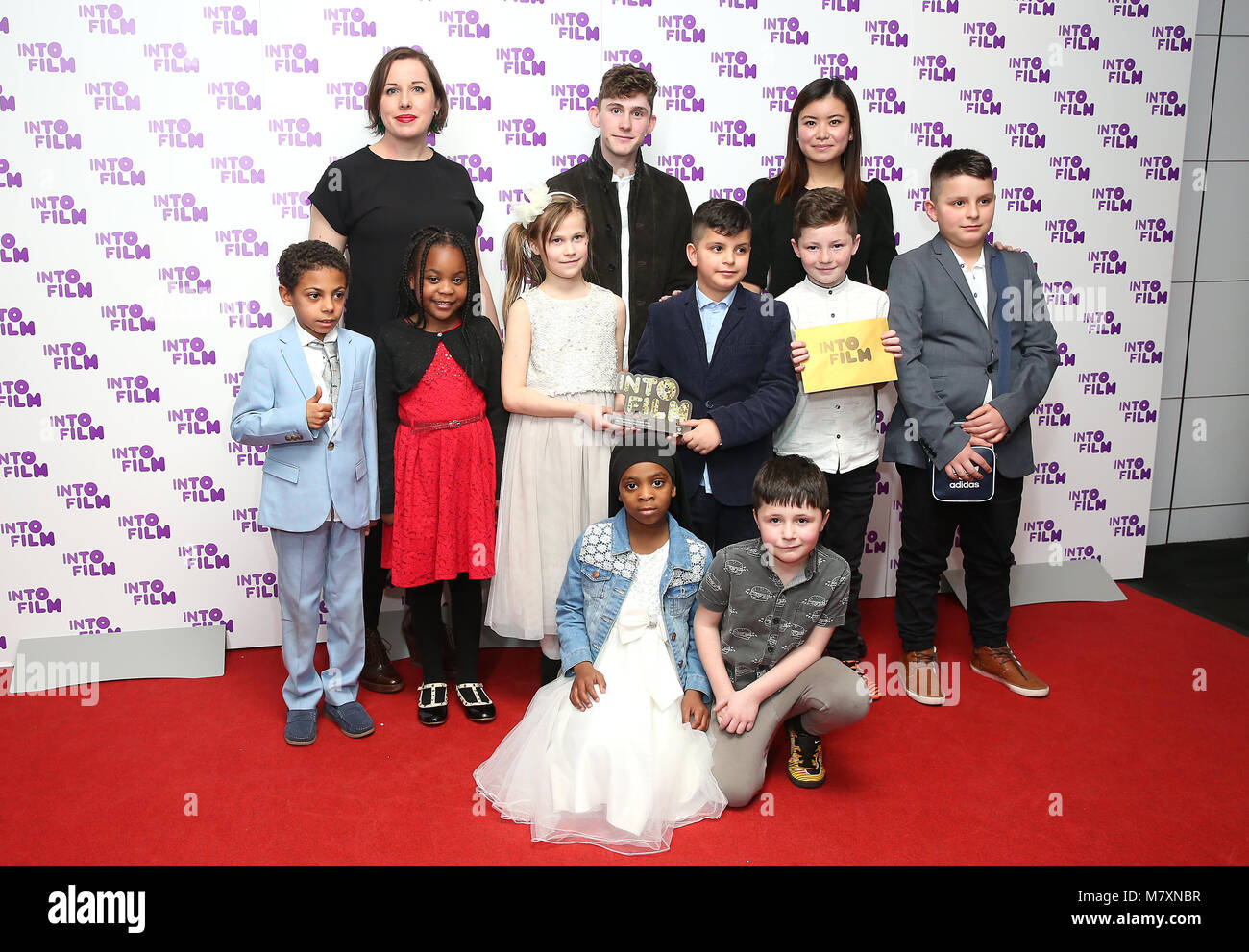 Fionn O'Shea (centre) and Katie Leung (right) present the award for Club of the Year (12 and under) to Horton Park Primary School in Bradford at the Into Film Awards 2018 held at the BFI Southbank, London. PRESS ASSOCIATION Photo. Picture date: Tuesday March 13, 2018. Photo credit should read: Isabel Infantes/PA Wire Stock Photo