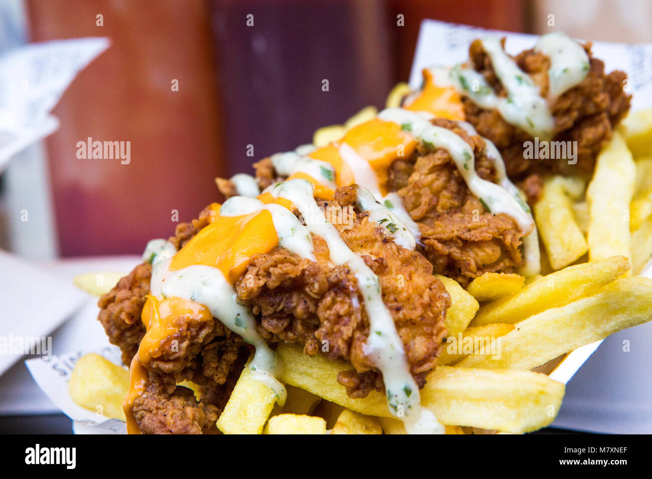 Fried chicken and chips with cheese. Stock Photo
